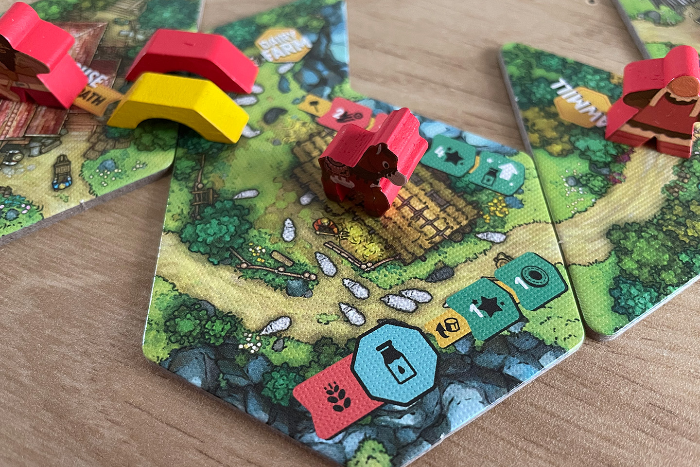 The dairy farm lets you turn wheat into milk. I suppose there's a cow involved in the process. Also note how both players have built a road to the Warehouse in the top left.